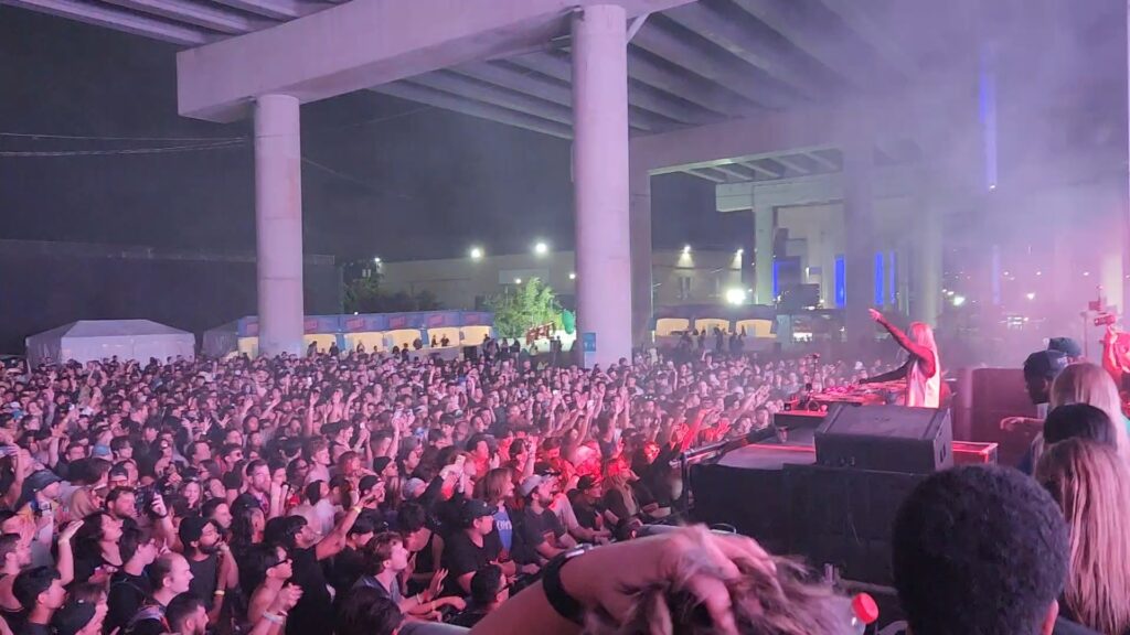 Alison Wonderland points to the crowd while on stage during her set.