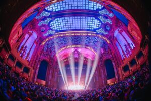 The inside of Brooklyn Paramount lit up in pastel colors for Of The Trees Moonglade Tour