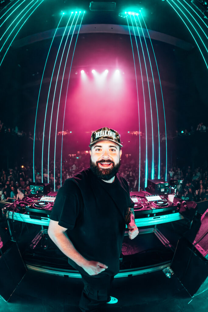 Heyz at the DJ decks with the laser cage behind him.